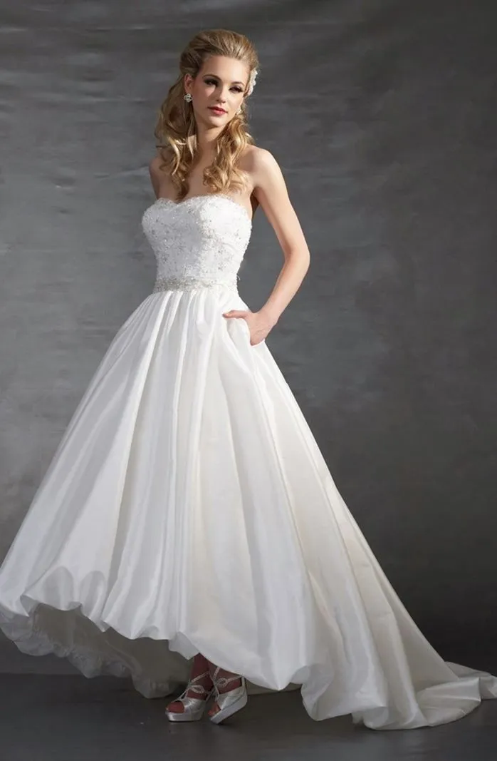 ---Tailored asymmetrical wedding dress short on the front and with train on the back, princess style with tone-on-tone lace appl